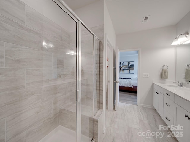 bathroom with vanity and an enclosed shower