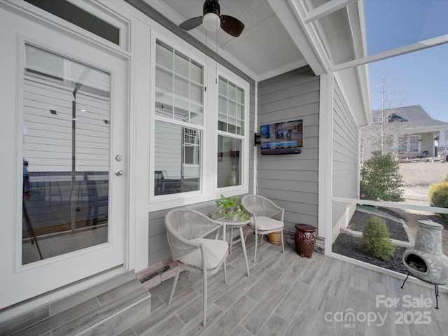 sunroom / solarium with ceiling fan