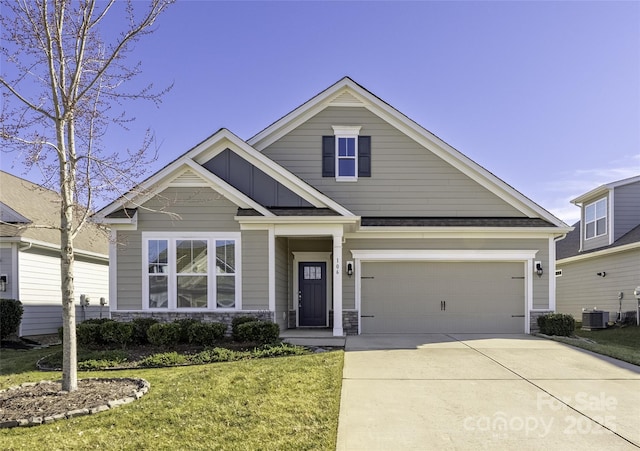 view of front of property with central AC and a front lawn