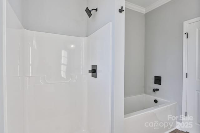 bathroom with ornamental molding and shower / bathtub combination