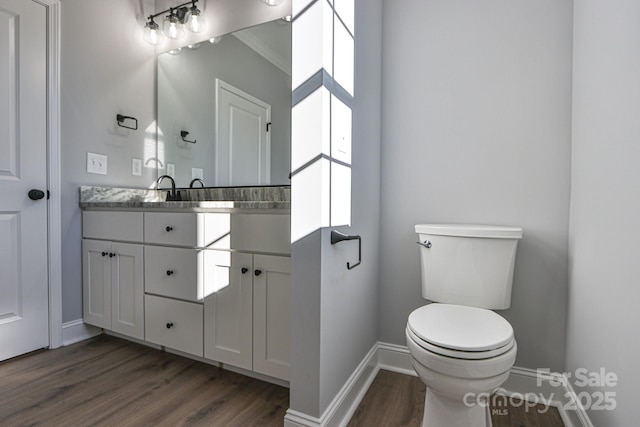 bathroom featuring hardwood / wood-style floors, toilet, and vanity