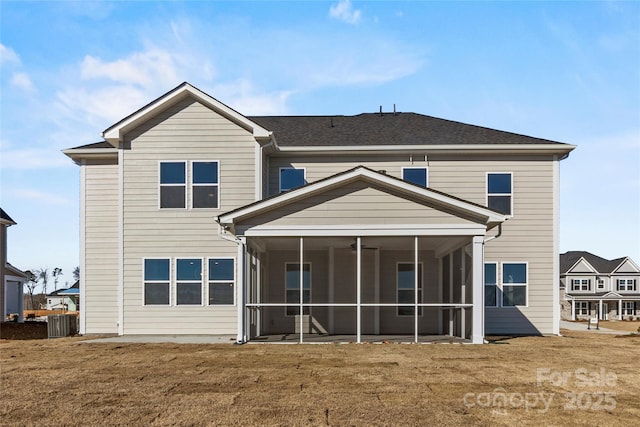 back of house with a sunroom and a yard