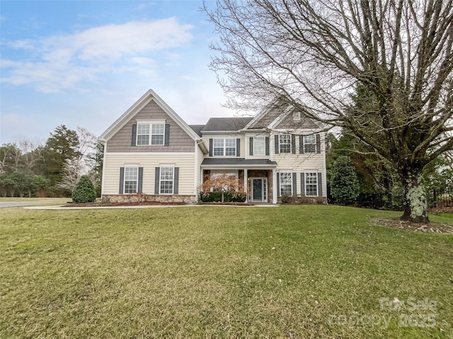 view of front of property with stone siding and a front lawn