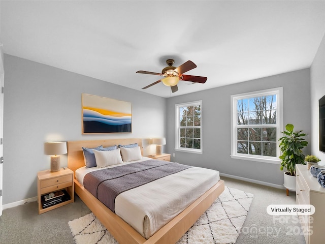 bedroom featuring baseboards, a ceiling fan, and light colored carpet