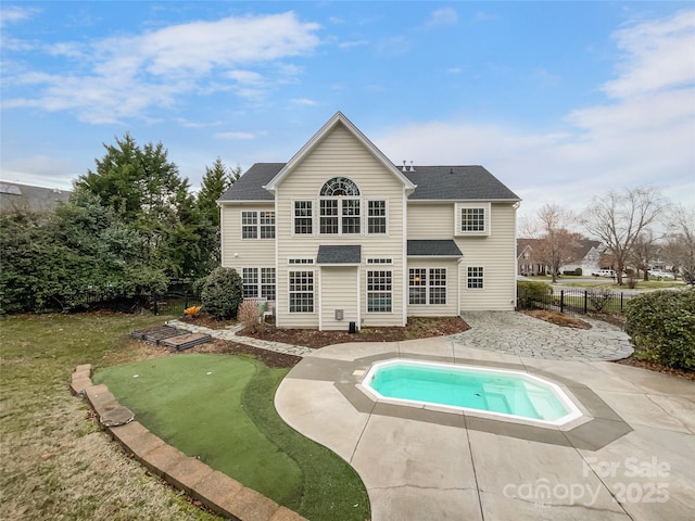 rear view of house with a patio area, fence, and roof with shingles