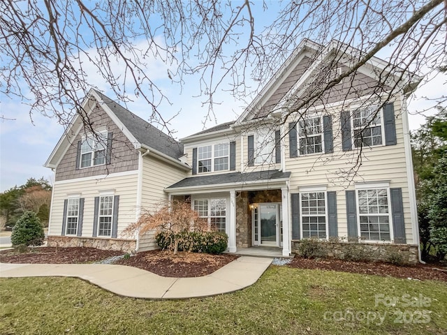 view of front of property featuring stone siding and a front yard