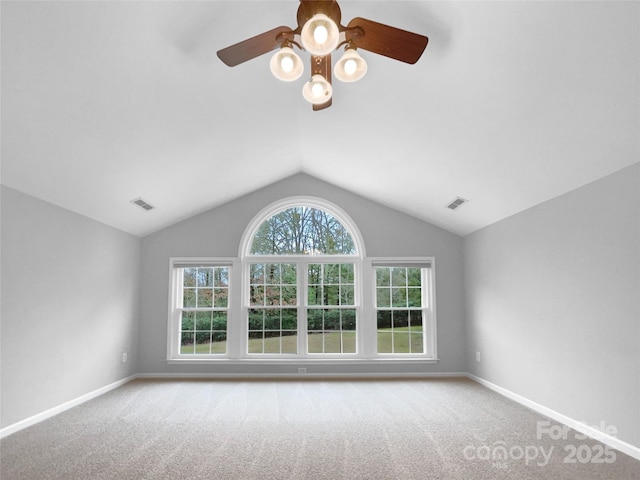 unfurnished room featuring baseboards, visible vents, vaulted ceiling, and light colored carpet