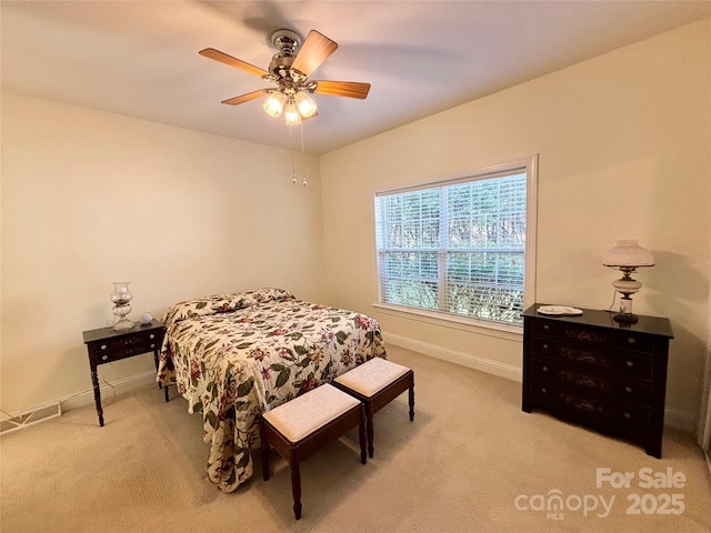 bedroom featuring light carpet and ceiling fan