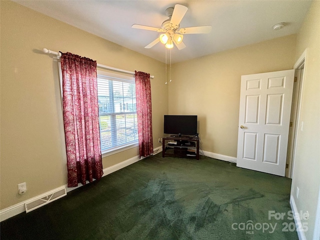 unfurnished bedroom featuring dark colored carpet and ceiling fan