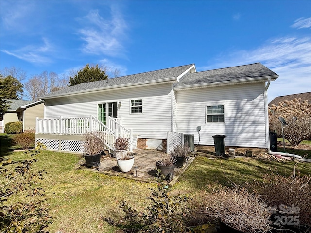 rear view of house with a wooden deck, a yard, and central air condition unit