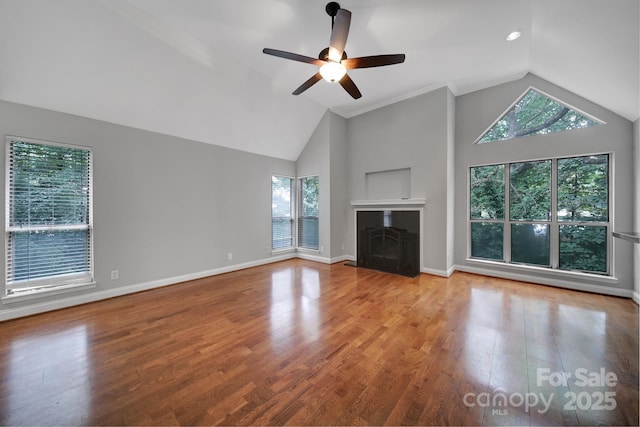 unfurnished living room with ceiling fan, high vaulted ceiling, and light hardwood / wood-style flooring