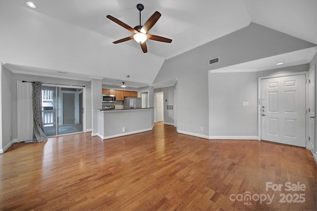 unfurnished living room featuring vaulted ceiling, crown molding, ceiling fan, and light wood-type flooring