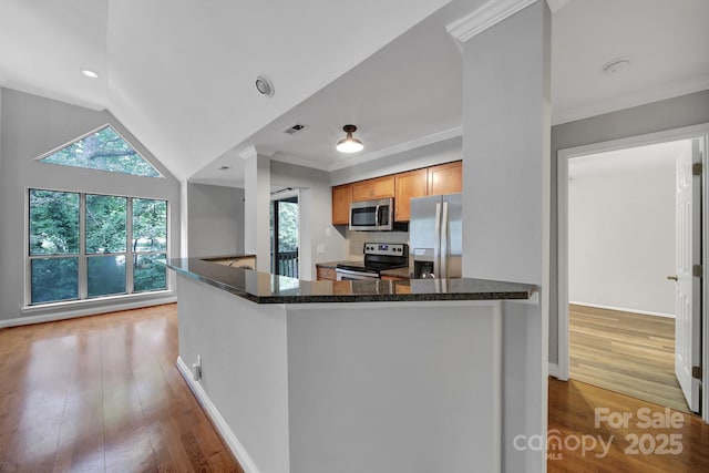 kitchen featuring ornamental molding, stainless steel appliances, and light hardwood / wood-style floors