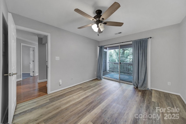 spare room featuring hardwood / wood-style flooring and ceiling fan