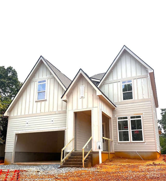 2530 Elkwood Cir, Charlotte, NC 28205 - view of front of home with board and batten siding, an attached garage, and driveway