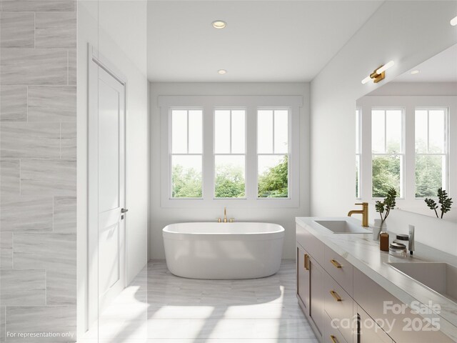 2530 Elkwood Cir, Charlotte, NC 28205 - full bathroom featuring plenty of natural light, a soaking tub, recessed lighting, and double vanity