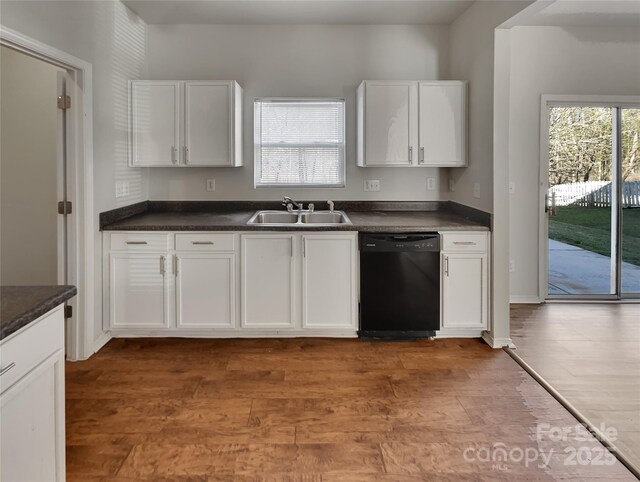 8353 Ainsworth St, Charlotte, NC 28216 - kitchen with wood finished floors, a sink, white cabinets, dishwasher, and dark countertops