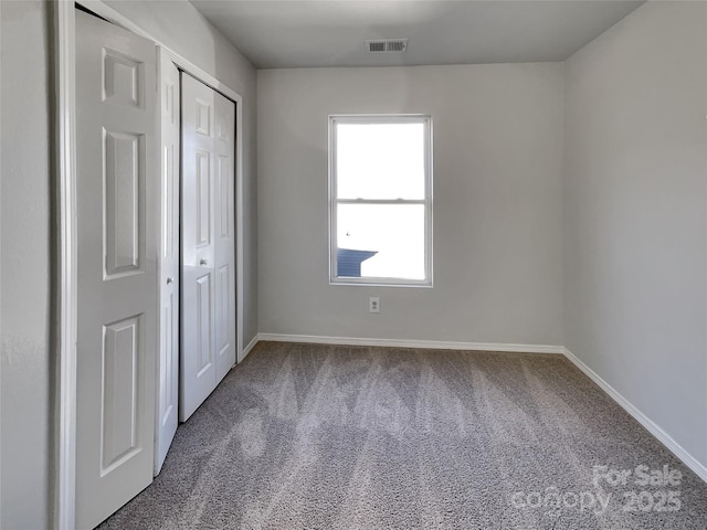8353 Ainsworth St, Charlotte, NC 28216 - unfurnished bedroom with carpet floors, a closet, visible vents, and baseboards