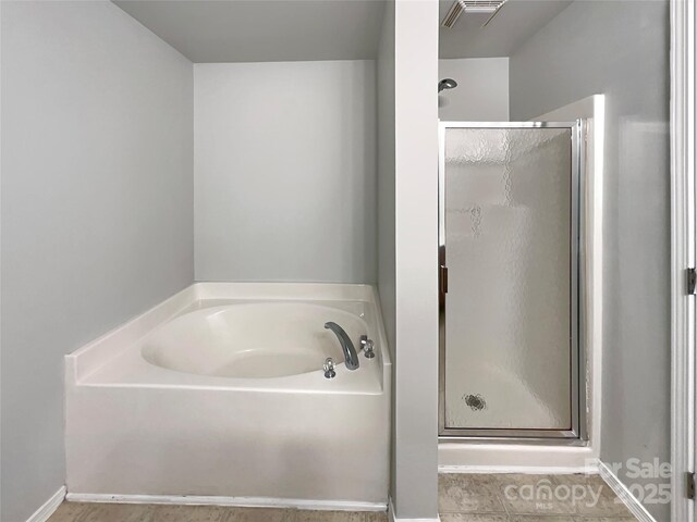 8353 Ainsworth St, Charlotte, NC 28216 - full bathroom featuring a stall shower, baseboards, visible vents, and a bath