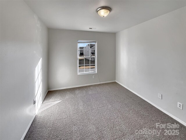 8353 Ainsworth St, Charlotte, NC 28216 - empty room featuring baseboards, a healthy amount of sunlight, visible vents, and carpet flooring