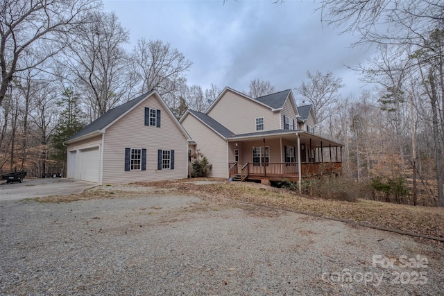 view of front of property featuring covered porch, concrete driveway, and a garage