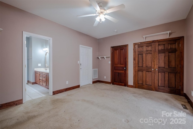 unfurnished bedroom with light carpet, visible vents, and baseboards