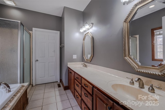 bathroom featuring a bath, a shower stall, a sink, and tile patterned floors