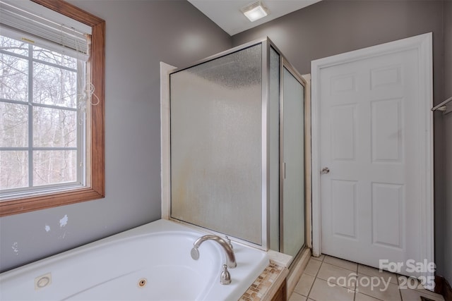 bathroom with tile patterned flooring, a shower stall, and a whirlpool tub