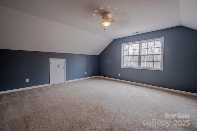 bonus room featuring baseboards, visible vents, ceiling fan, vaulted ceiling, and carpet flooring