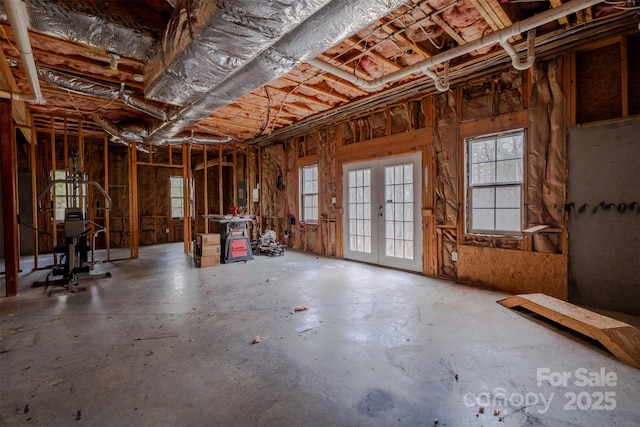 miscellaneous room with concrete flooring and french doors