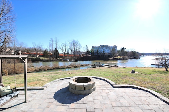 view of patio / terrace featuring a water view and an outdoor fire pit