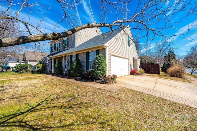 view of side of home featuring a yard and a garage