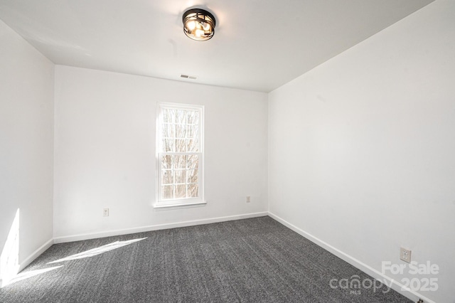 empty room featuring dark colored carpet