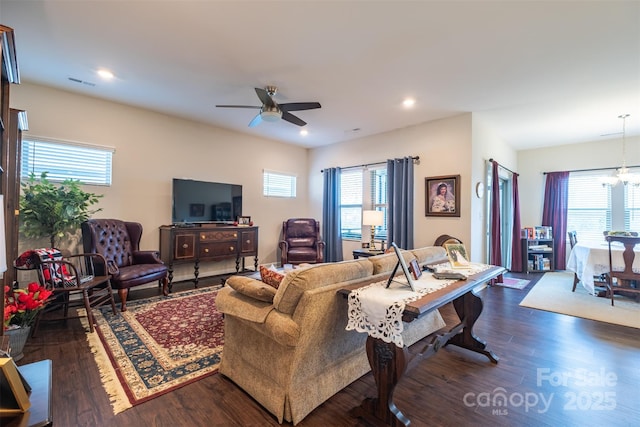 living area with recessed lighting, dark wood-style floors, plenty of natural light, and ceiling fan with notable chandelier