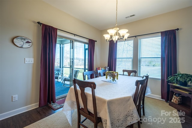 dining space with a chandelier, baseboards, visible vents, and a healthy amount of sunlight