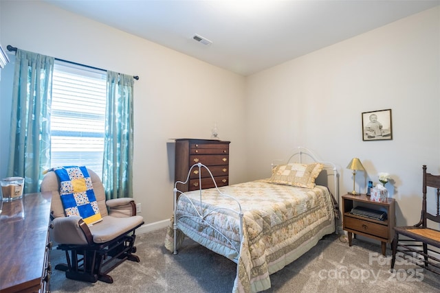 bedroom with carpet flooring, visible vents, and baseboards