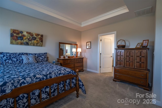 bedroom featuring baseboards, visible vents, ornamental molding, a tray ceiling, and carpet floors