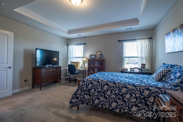 carpeted bedroom with ornamental molding, a raised ceiling, and multiple windows