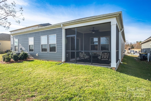 back of house featuring a yard, a sunroom, and a ceiling fan