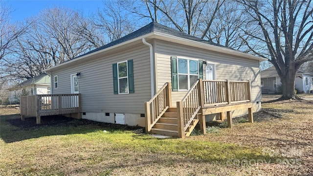 back of property featuring a yard and a deck