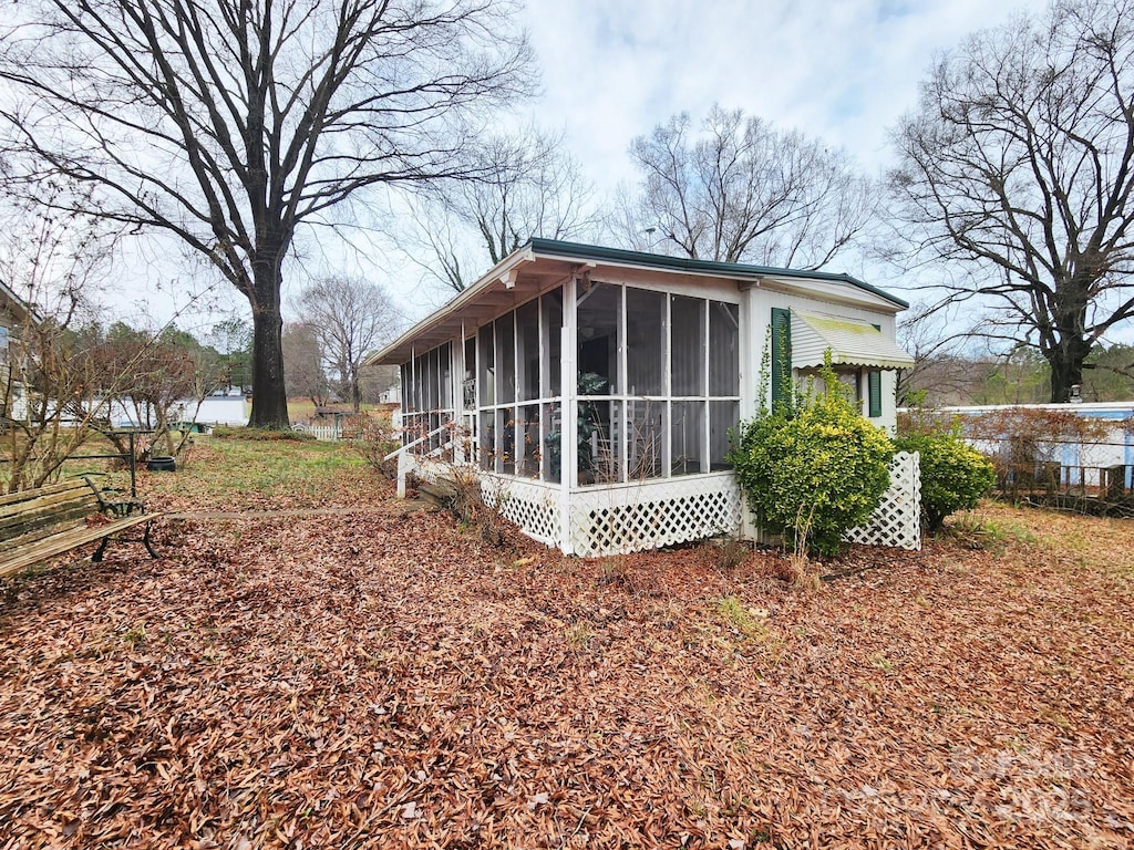 view of home's exterior with a sunroom