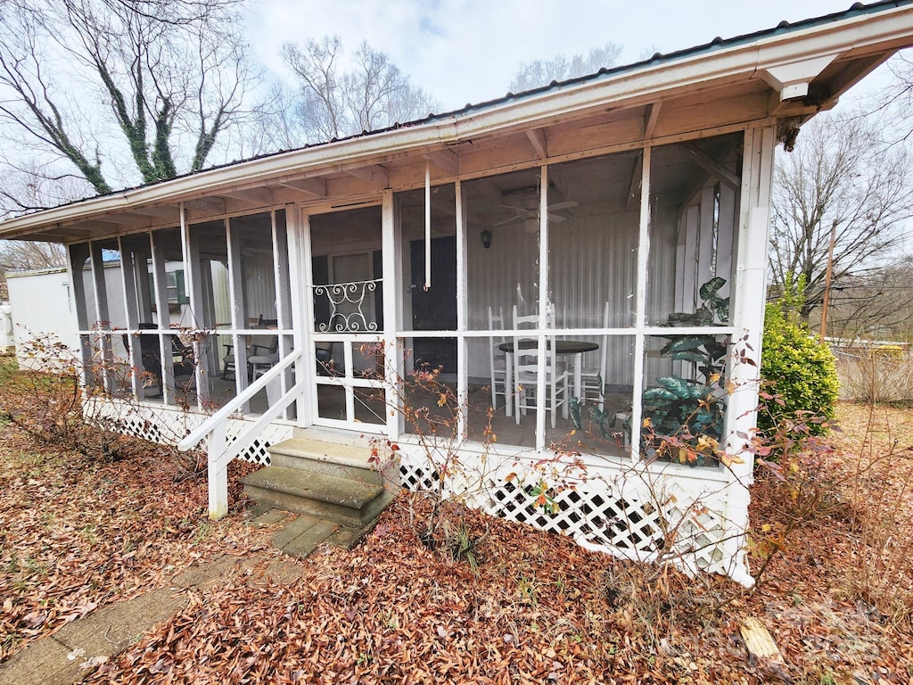 rear view of property with a sunroom