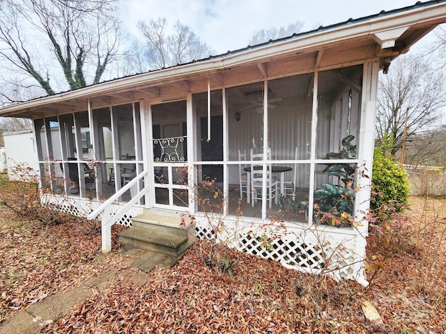 rear view of property with a sunroom