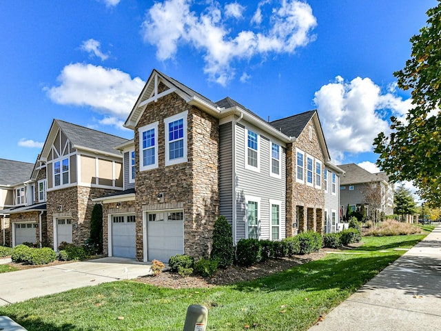 view of side of property with a garage and a yard