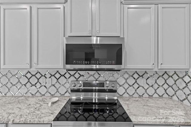 kitchen featuring white cabinets and appliances with stainless steel finishes