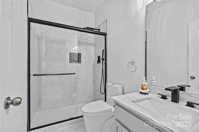 bathroom featuring vanity, toilet, and walk in shower