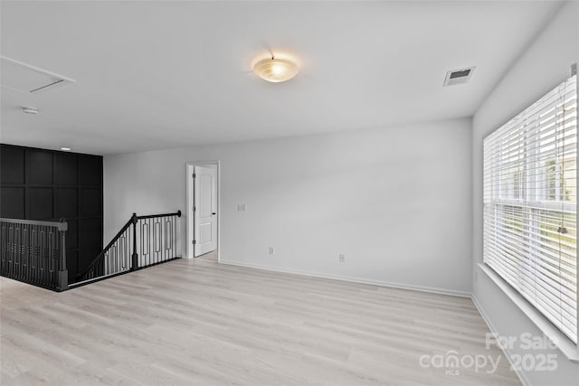 spare room featuring light hardwood / wood-style flooring