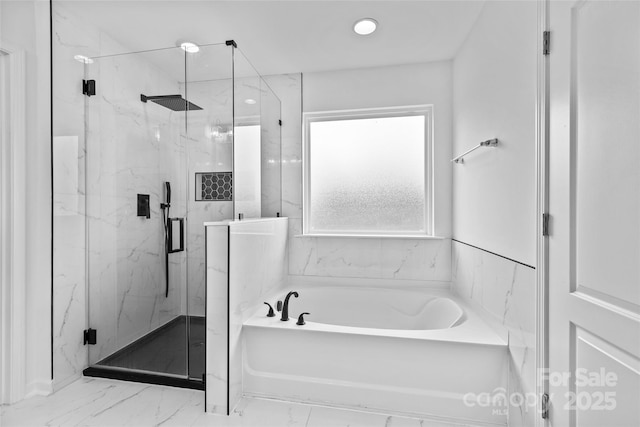 bathroom with separate shower and tub