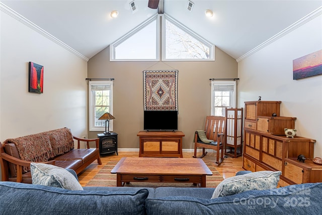 living area featuring light wood finished floors, plenty of natural light, visible vents, and crown molding