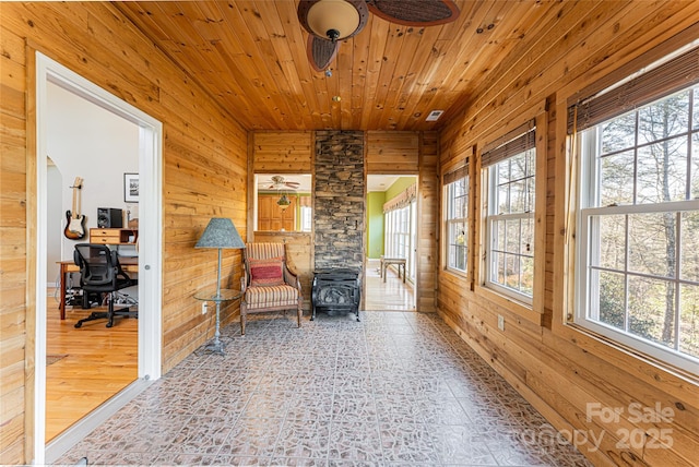 sitting room with wood walls and wood ceiling